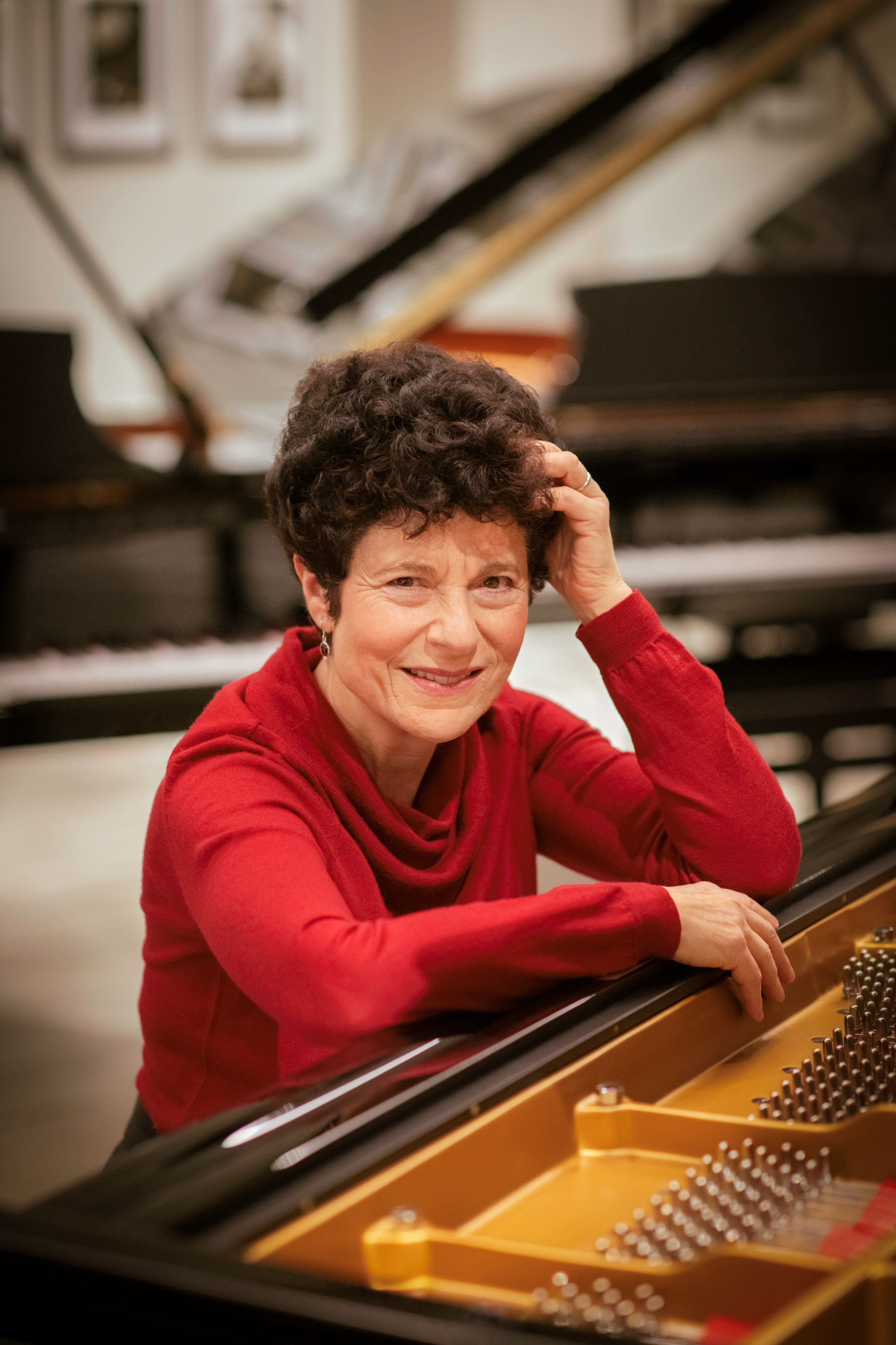 woman smiling sat at piano