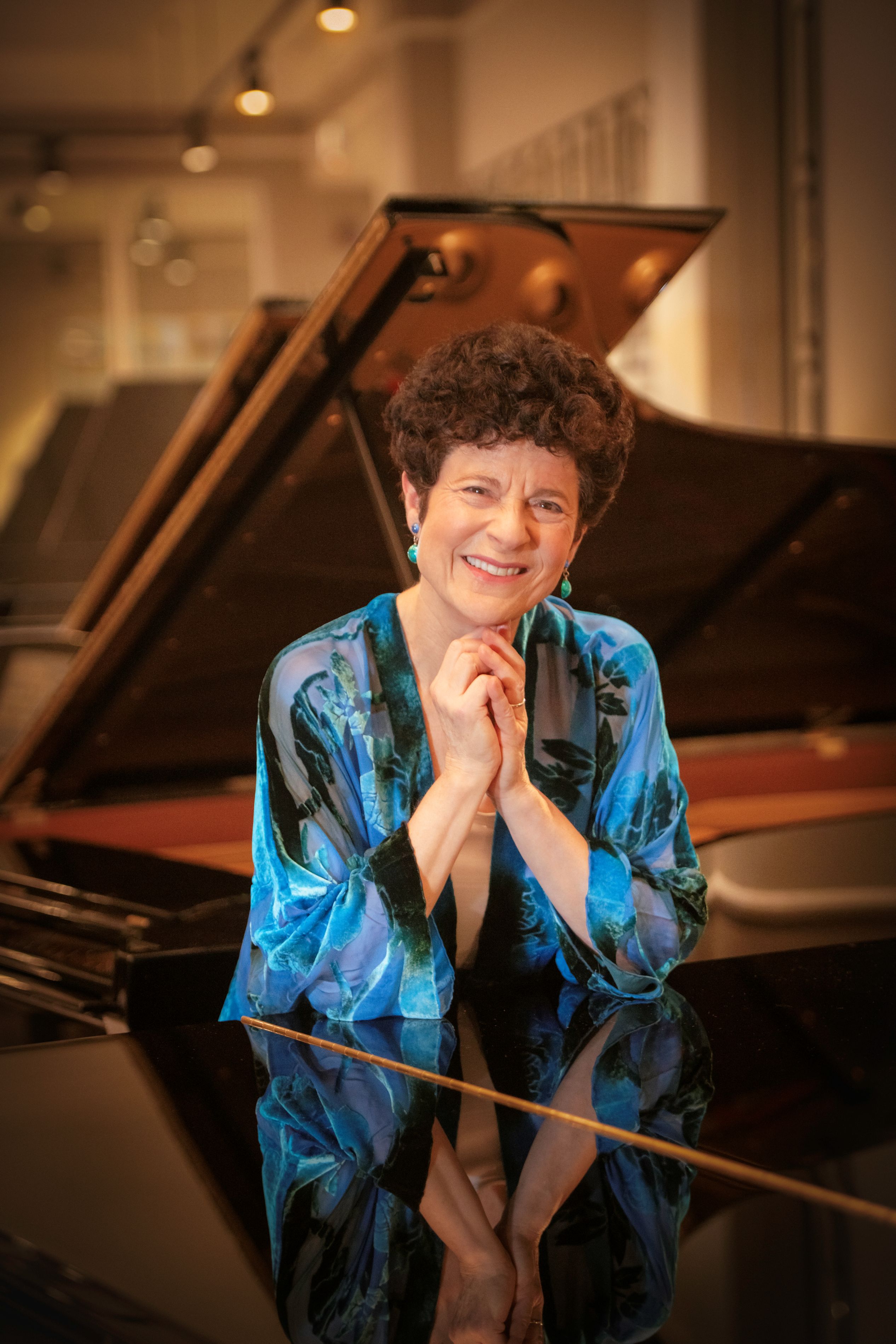 woman smiling sitting at piano